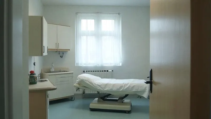Behandlungszimmer einer Kinderarztpraxis mit Liege, Schrank und Waschbecken